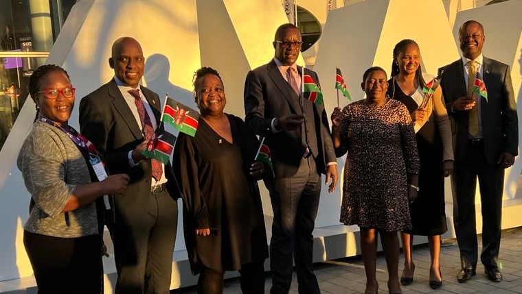 Mr. Eliud Owalo, the Cabinet Secretary for Information, Communications and the Digital Economy (centre) with the Kenyan delegation to the Mobile World Congress in Barcelona, Soain wave flags upon the the announcement of Kenya's successful bid to host the Transform Africa Summit.