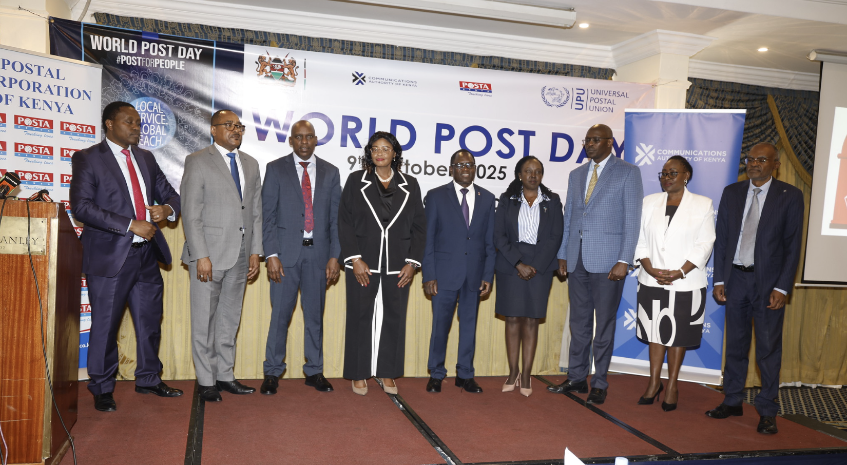 PS Stephen Isaboke poses for a group photo with CA DIrector General, David Mugonyi and Post Master General John Tanui