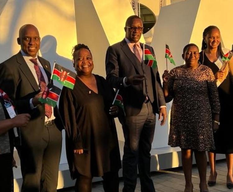 Mr. Eliud Owalo, the Cabinet Secretary for Information, Communications and the Digital Economy (centre) with the Kenyan delegation to the Mobile World Congress in Barcelona, Soain wave flags upon the the announcement of Kenya's successful bid to host the Transform Africa Summit.